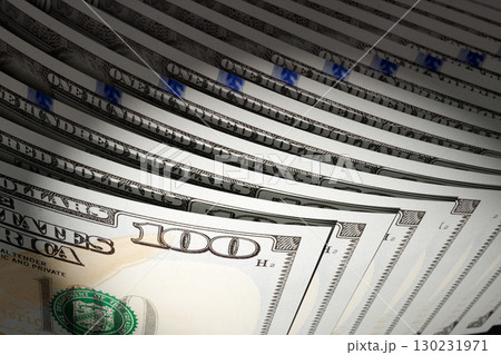 Spot Lit Abstract CLose-up Angle of U.S. 100 Dollar Bills Isolated on a Black Background. Spot Lit Abstract CLose-up Angle of U.S. 100 Dollar Bills Isolated on a Black Background. 130231971