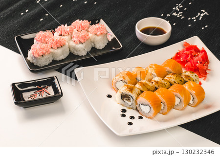 delicious sushi platter with salmon rolls, spicy tuna rolls, and wasabi served. closeup. 130232346