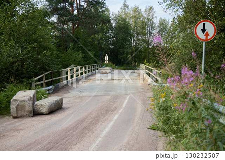 A Deserted Bridge that is Completely Surrounded by Lush Nature and Overgrown Vegetation A Deserted Bridge that is Completely Surrounded by Lush Nature and Overgrown Vegetation 130232507