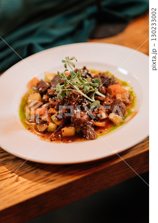 Elegant gourmet beef stew served at a romantic candlelit dinner celebration 130233002