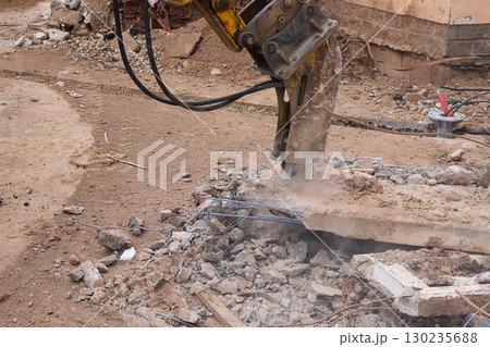 A bustling construction site filled with heavy machinery and ongoing demolition work 130235688