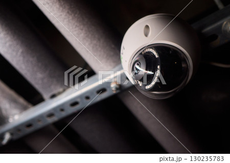 Surveillance Camera Placed in an Industrial Setting Surrounded by Various Pipes and Equipment Surveillance Camera Placed in an Industrial Setting Surrounded by Various Pipes and Equipment 130235783
