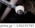 Surveillance Camera Placed in an Industrial Setting Surrounded by Various Pipes and Equipment 130235785