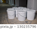 A Collection of Various White Buckets Displayed in a Neat Indoor Setting for Use 130235796