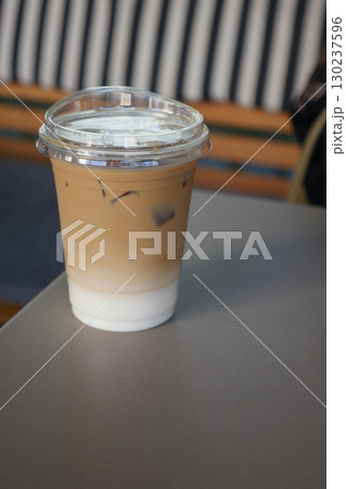 Iced coffee on a table in a cozy cafe setting 130237596