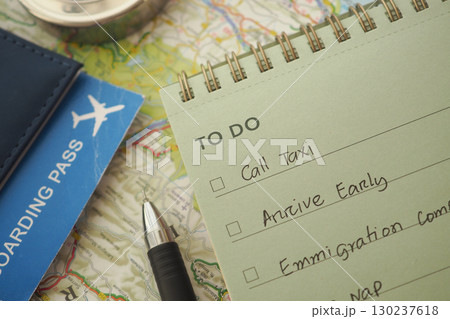 Travel planning checklist with a boarding pass on a map Travel planning checklist with a boarding pass on a map 130237618