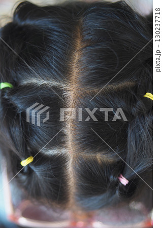 Cute hairstyle with colorful hair ties on black hair 130237718
