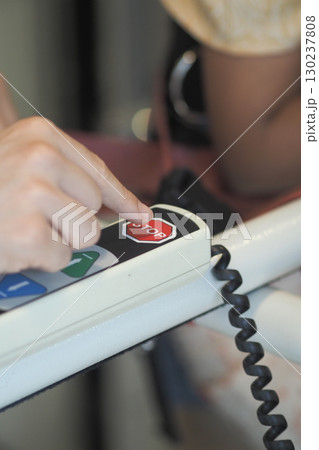 Hand pressing stop button in busy setting Hand pressing stop button in busy setting 130237808