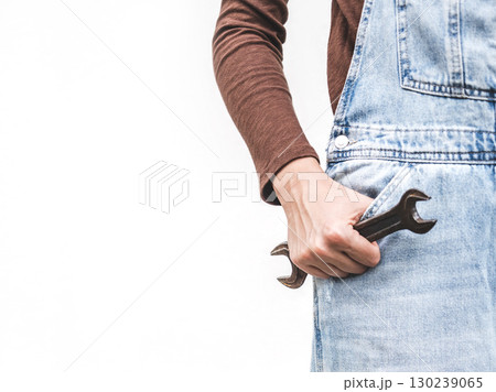 Cute woman, work clothes and wrench. Studio shot. 130239065