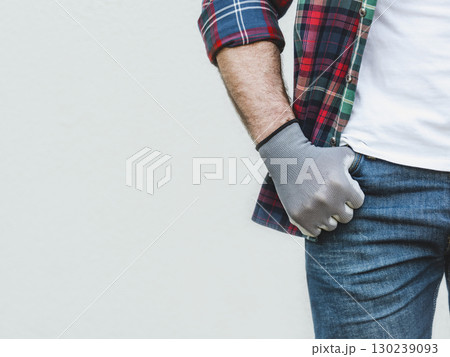 Attractive man, work clothes and protective gloves 130239093