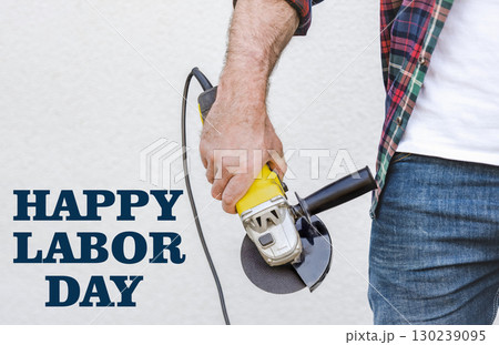 Happy Labor Day. Attractive man and angle grinder 130239095