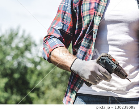 Attractive man, screwdriver and work clothes Attractive man, screwdriver and work clothes 130239098
