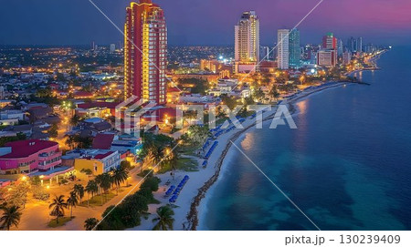 Coastal Cityscape at Twilight: Illuminated Buildings and Tranqui 130239409