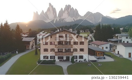 Alpine Sunset View of a Multi-Story House near Majestic Peaks 130239441