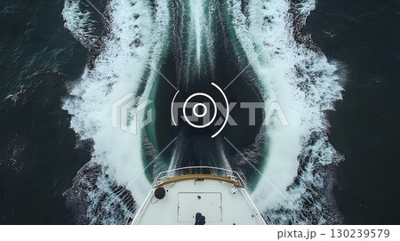 Yacht's wake creates foamy patterns in the dark ocean, viewed fr 130239579
