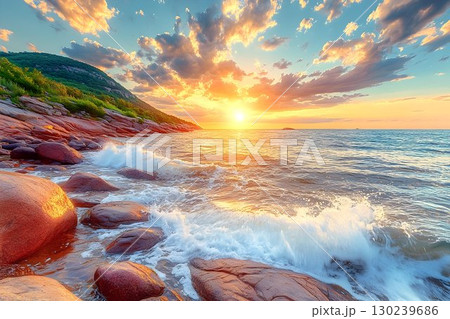 Coastal Sunrise: Waves Crashing on Rocky Shore with Golden Light 130239686