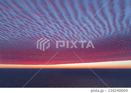 Pink and Blue Undulating Cloudscape Over Calm Ocean at Sunset 130240004
