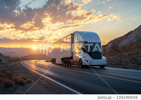 modern white semi truck drives along winding highway through rugged mountains at sunset, creating stunning golden scene modern white semi truck drives along winding highway through rugged mountains at sunset, creating stunning golden scene 130240848