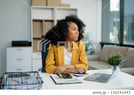 Confident woman with a smile standing holding notepad and tablet 130241443