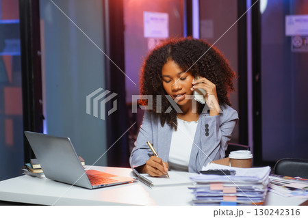 Woman feeling migraine head strain.Overworked businesswoman financier while working on laptop and tablet 130242316