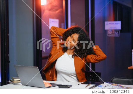 Woman feeling migraine head strain.Overworked businesswoman financier while working on laptop and tablet Woman feeling migraine head strain.Overworked businesswoman financier while working on laptop and tablet 130242342