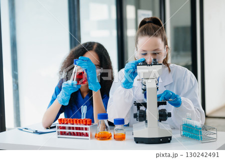 Scientist two woman with tablet and laptop, laboratory and ecofriendly science. Agriculture, research and scientists with online reading, test samples Scientist two woman with tablet and laptop, laboratory and ecofriendly science. Agriculture, research and scientists with online reading, test samples 130242491