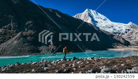 Backpacking woman hiking on high altitude mountains 130242559