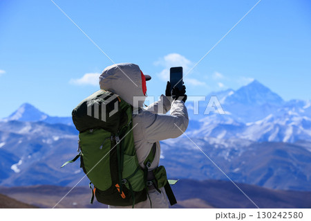 Successful woman hiker hiking to Mount Everest in Tibet, China 130242580
