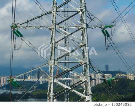 Aerial view of high voltage electricity tower on mountain 130243056