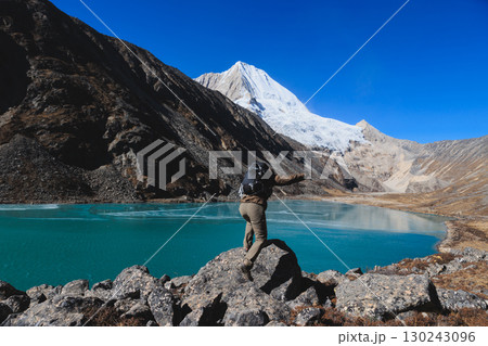 Backpacking woman hiking on high altitude mountain top Backpacking woman hiking on high altitude mountain top 130243096