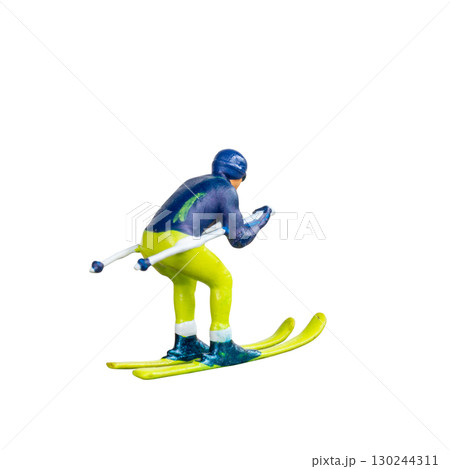 Miniature skier figure standing alone on white background with clean clipping path Miniature skier figure standing alone on white background with clean clipping path 130244311
