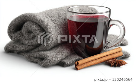 Warm mulled wine with spices and cozy blanket creating winter comfort 130246564