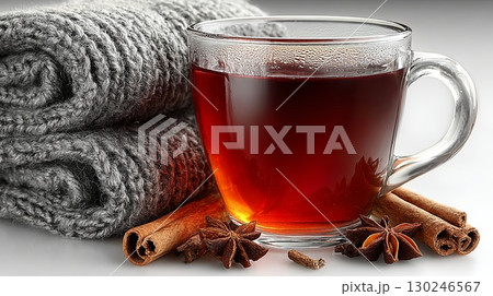 Warm mulled wine with spices and cozy blanket creating winter comfort 130246567