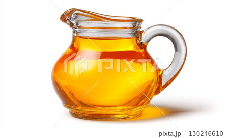 Small glass pitcher containing fresh vegetable oil on white background 130246610