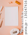 White notebook with sewing supplies and measuring tape flat lay 130247416