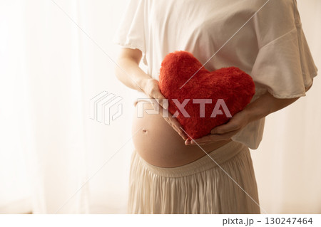 赤いハートを持つ妊娠8ヶ月の女性 130247464