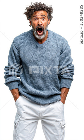A man in a blue sweater with his hands in his pockets 130249285