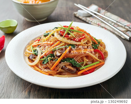 Delicious Korean Japchae Stir Fried Glass Noodles with Vegetables and Beef in White Plate 130249692