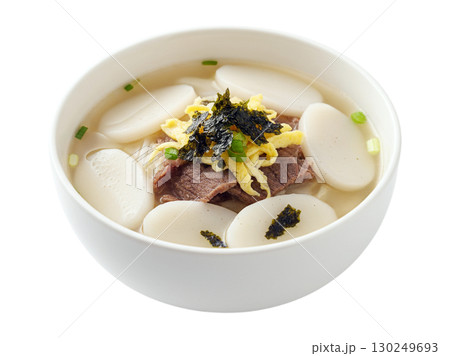 Traditional Korean Rice Cake Soup with Beef and Egg Garnish in White Bowl 130249693