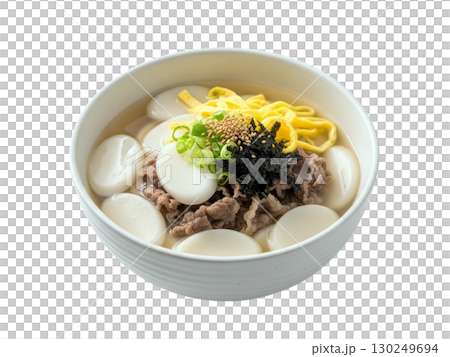 Traditional Korean Rice Cake Soup with Beef and Egg Garnish in White Bowl Traditional Korean Rice Cake Soup with Beef and Egg Garnish in White Bowl 130249694