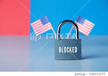 Closed padlock with the inscription lock on the background of the flag of USA Closed padlock with the inscription lock on the background of the flag of USA 130251277