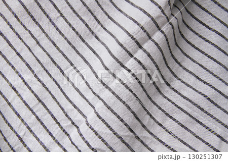 Plaid material. Towel on the table. Wrinkled fabric with stripes. 130251307