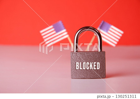 Closed padlock with the inscription lock on the background of the flag of USA. 130251311