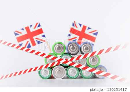 Battery. A lot of batteries on the background of the flag of the country. Battery. A lot of batteries on the background of the flag of the country. 130251417