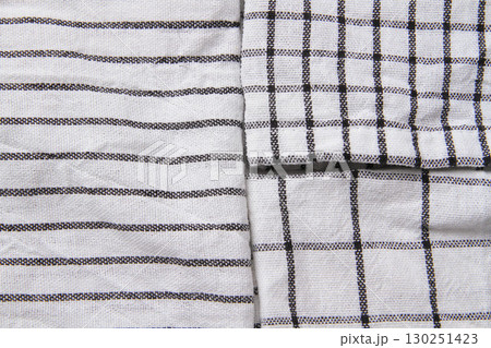 Plaid material. Towel on the table. Wrinkled fabric with stripes. 130251423