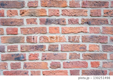 Brown structural stone wall of the ancient building consists of bricks. Nature structural background. 130251498