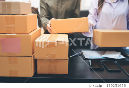 Portrait of Starting small businesses SME owners, two Asian woman check online orders Selling products working with boxs freelance work at home office, sme business online small medium enterprise 130251636