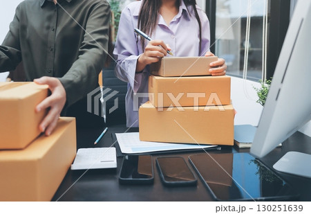 Portrait of Starting small businesses SME owners, two Asian woman check online orders Selling products working with boxs freelance work at home office, sme business online small medium enterprise 130251639