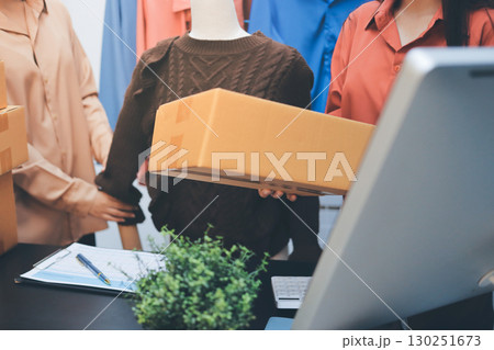 Portrait of Starting small businesses SME owners, two Asian woman check online orders Selling products working with boxs freelance work at home office, sme business online small medium enterprise 130251673