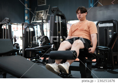 Fat Asian man playing with equipment Fitness to lose weight in the gym. Fat Asian man playing with equipment Fitness to lose weight in the gym. 130251876